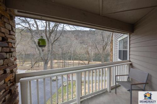 a screened in porch with a chair and a window at 3BR Condo with Lake View - Trout Fishing - Playground - 2 Pools - Stairs Required - FREE TICKETS INCLUDED - PR69-9 in Branson