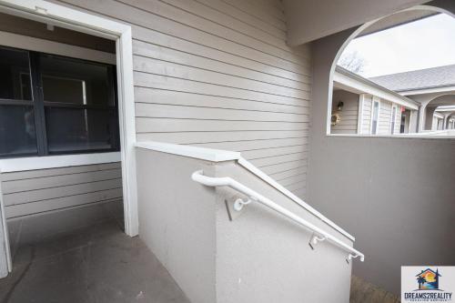 a door to a house with a handrail and a window at 3BR Condo with Lake View - Trout Fishing - Playground - 2 Pools - Stairs Required - FREE TICKETS INCLUDED - PR69-9 in Branson