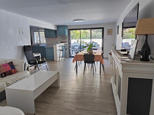Il comprend un salon et une cuisine avec une table et un canapé. dans l'établissement Etoile de Mer - Appt 3 ch 2 sdb à 150m d'une plage de sable fin hyper équipé & Wifi, à Saint-Mandrier-sur-Mer