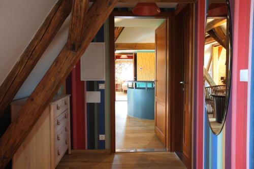 a hallway with an open door in a house at Swiss villa in the Danube Bend in Nagymaros
