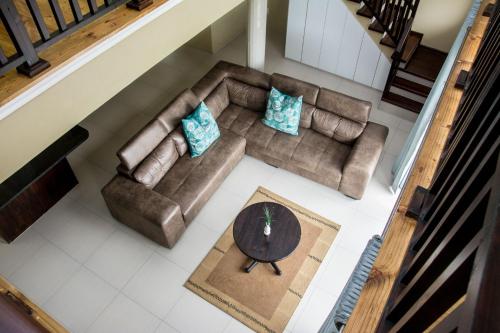 an overhead view of a living room with a couch and a table at Ocean Breeze Beach House in Port Shepstone