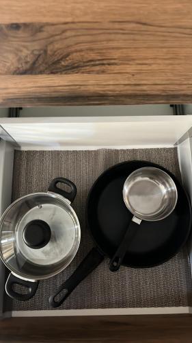 two frying pans sitting in a stove top oven at Flat in Olhão city center in Olhão