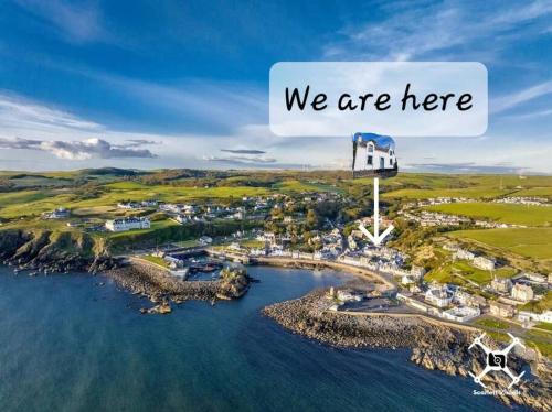 an island in the water with a sign that says we are here at The Portpatrick Pad - A cosy 3 bed cottage, w. sea views & garden office in Portpatrick