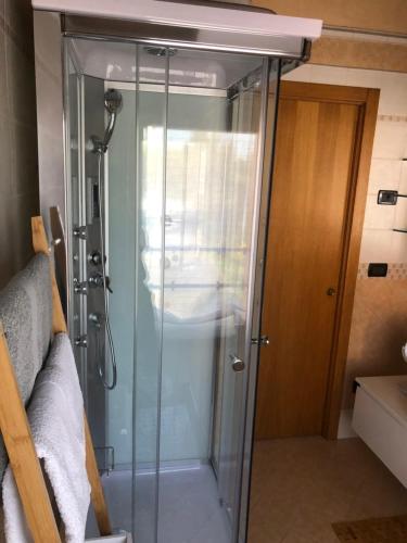 a shower with a glass door in a bathroom at Villa Trevisi - APARTMENT in Treviso