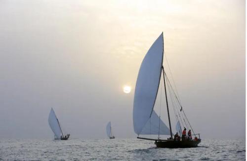 three sailboats on the water in the ocean at Fabulous Luxury Room in Abu Dhabi