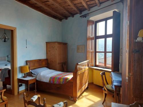 Postel nebo postele na pokoji v ubytování Dimora Da Feliciano bellezza, tanto spazio e tranquillità nella collina torinese