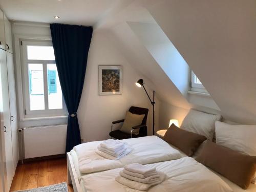 a bedroom with a bed with white sheets and a window at Villa Johanna in Bad Herrenalb