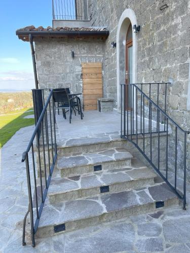 a stone house with stairs leading to a door at Villa Paladini in Montefiascone