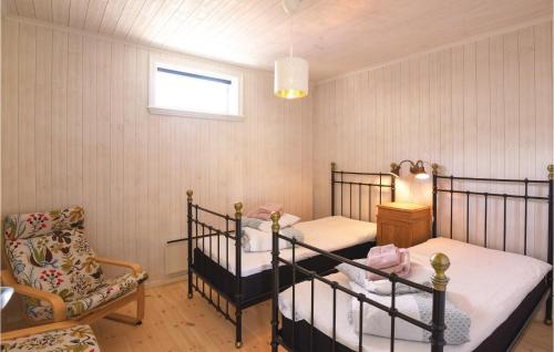 a bedroom with two bunk beds and a chair at Nice Home In Hinds With 1 Bedrooms And Wifi in Hindås