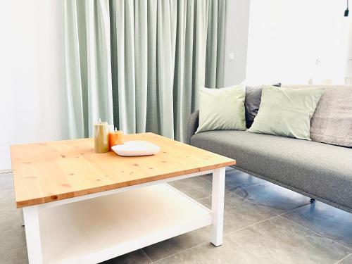 a living room with a couch and a coffee table at Vixen Apartment Studio 2 in Theologos