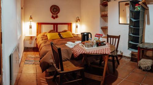 1 dormitorio con 1 cama, mesa y sillas en Casa de la Flia. Sánchez en Humahuaca