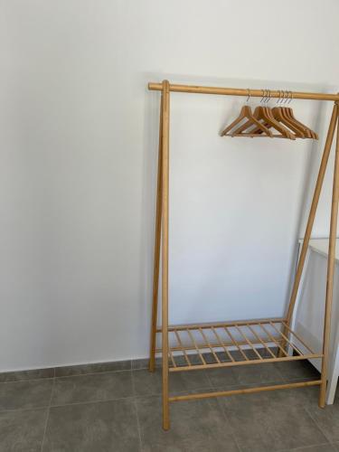 a wooden stand in a room with a white wall at Vixen Apartment Studio 2 in Theologos