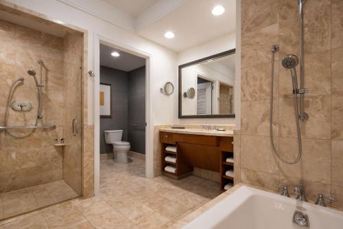 a bathroom with a tub and a shower and a sink at The Ritz-Carlton, Boston in Boston