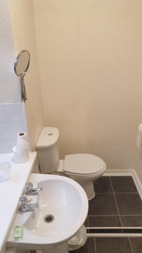 a bathroom with a white toilet and a sink at HOTEL242 in Blackpool