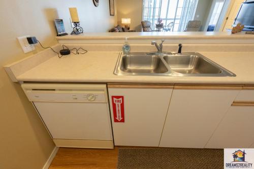 a kitchen with a sink and a counter at 2BR Walk-In Condo - Near The Strip - FREE TICKETS INCLUDED - CH1-18 in Branson