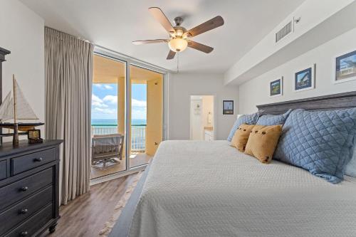 a bedroom with a bed with a ceiling fan at Beach Colony East 17B-Penthouse in Perdido Key