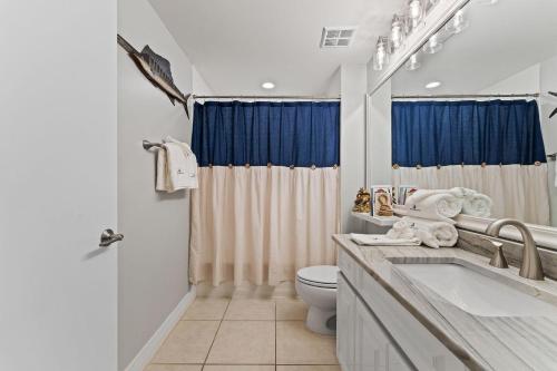 a bathroom with a toilet and a tub and a sink at Beach Colony East 17B-Penthouse in Perdido Key