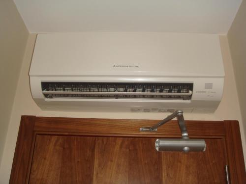 a white air conditioner on top of a wall at Pensión Residencial Platas in O Pedrouzo