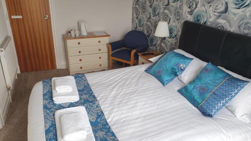 a bedroom with a bed with two towels on it at HOTEL242 in Blackpool