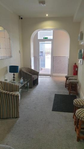 a living room with two couches and an open door at HOTEL242 in Blackpool