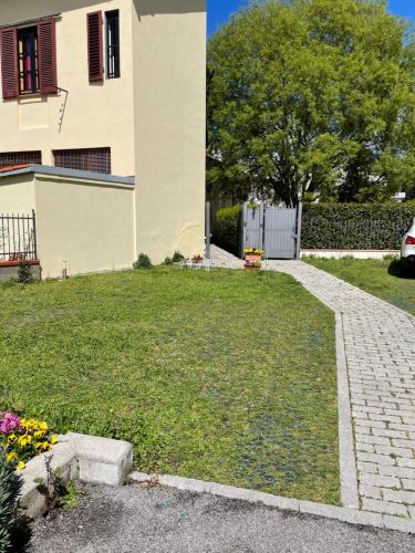 a house with a brick walkway in front of a yard at DaLu Florence apartment Lucilla - private car park 15 minutes to the city center in Florence
