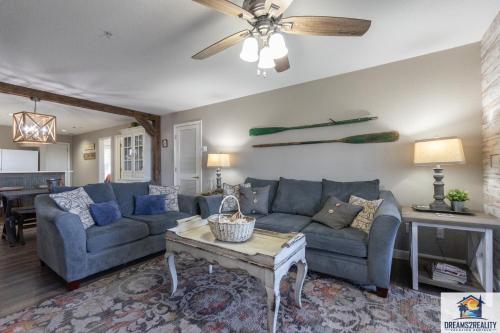 a living room with a blue couch and a table at 3BR Updated Walk-In Condo - Near the Strip - FREE TICKETS INCLUDED - CH4-4 in Branson