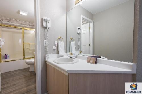 a bathroom with a sink and a mirror at 3BR Updated Walk-In Condo - Near the Strip - FREE TICKETS INCLUDED - CH4-4 in Branson