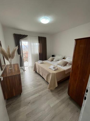 a bedroom with two beds and a large window at Apartment Ana in Imotski