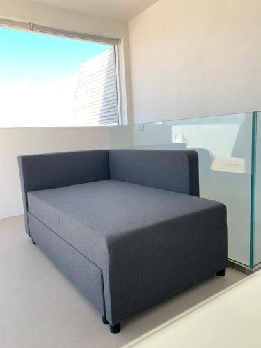 a bed in a room with a window at Poetto Apartment in Quartu SantʼElena