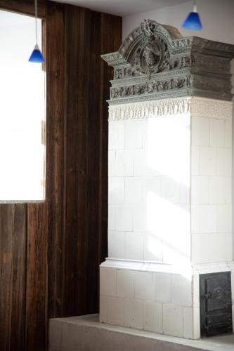 a brick fireplace in a room with a window at Młyn Klekotki Spa Resort in Klekotki