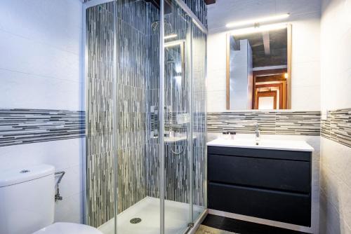 ein Badezimmer mit Dusche, Toilette und Waschbecken in der Unterkunft Vivienda Vacacional La Prida in Cangas de Onís