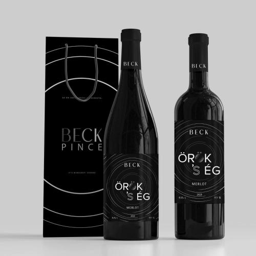 two bottles of red wine next to a box at Nagypince Borhotel Wine and Spa in Böhönye