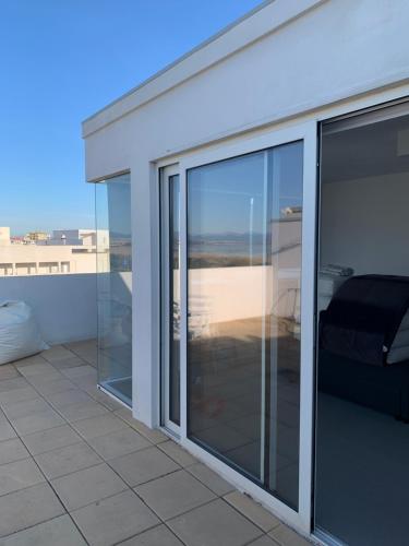 a room with sliding glass doors on a balcony at Poetto Apartment in Quartu SantʼElena