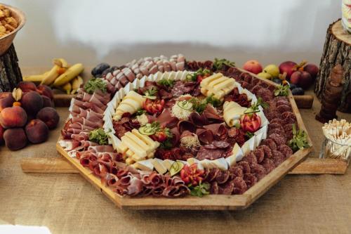a platter of meat and cheese on a table at Nagypince Borhotel Wine and Spa in Böhönye