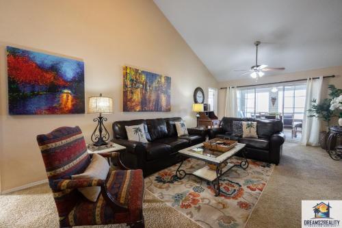 a living room with a couch and a table at 3 BR Condo - Near the Strip - Jacuzzi Tub - Stairs Required - FREE TICKETS INCLUDED - CH4-5 in Branson