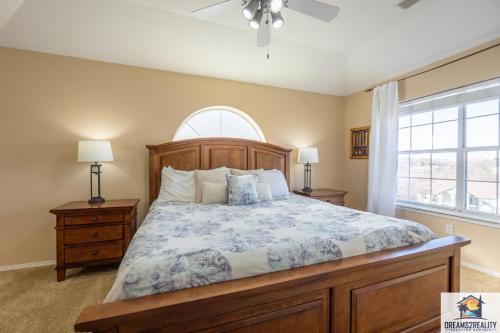 a bedroom with a large bed and a window at 3 BR Condo - Near the Strip - Jacuzzi Tub - Stairs Required - FREE TICKETS INCLUDED - CH4-5 in Branson