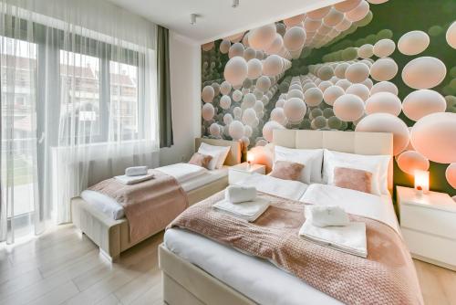 1 dormitorio con 2 camas y una pared con globos en Villa Garden, en Eger