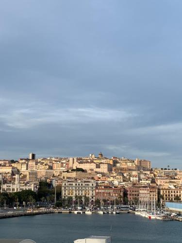 a view of a city with boats in the water at Poetto Apartment in Quartu SantʼElena