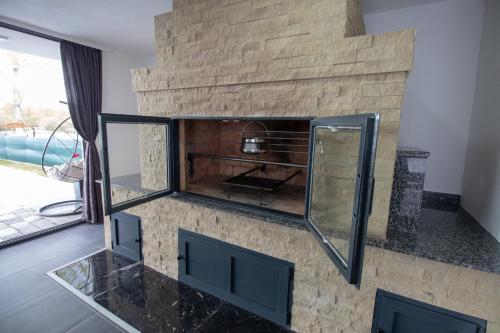 a room with a stone wall with a glass counter top at Vikendica na Drini - Drinska priča in Loznica