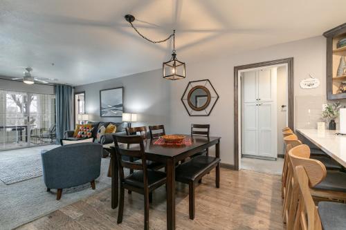 a dining room and living room with a table and chairs at 3BR Updated Condo - Family Games - Enclosed Patio - Stairs Required - FREE TICKETS INCLUDED - CH3-2 in Branson