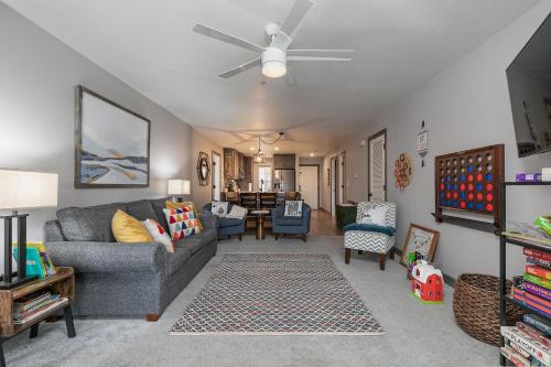 a living room with a couch and a ceiling fan at 3BR Updated Condo - Family Games - Enclosed Patio - Stairs Required - FREE TICKETS INCLUDED - CH3-2 in Branson