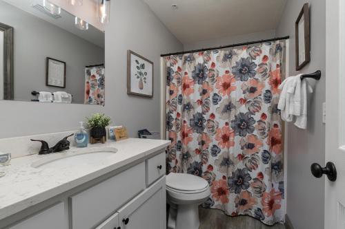 a bathroom with a toilet and a shower curtain at 3BR Updated Condo - Family Games - Enclosed Patio - Stairs Required - FREE TICKETS INCLUDED - CH3-2 in Branson