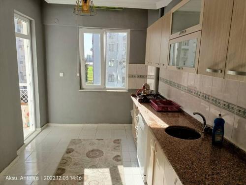 a kitchen with a sink and a window at 3+1 daire.hızlı Wifi,havalimanı plaj, market yakın in Antalya