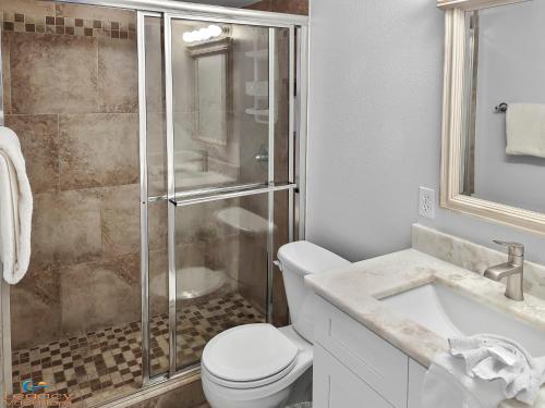 a bathroom with a shower and a toilet and a sink at IS9-Cozy Upstairs Beachfront Condo - King Beds in Fort Walton Beach