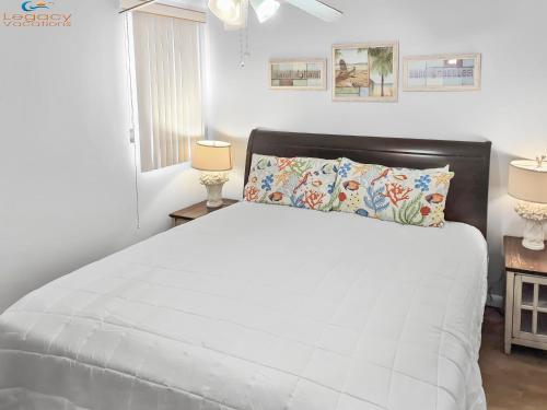a bedroom with a white bed and two lamps at IS9-Cozy Upstairs Beachfront Condo - King Beds in Fort Walton Beach