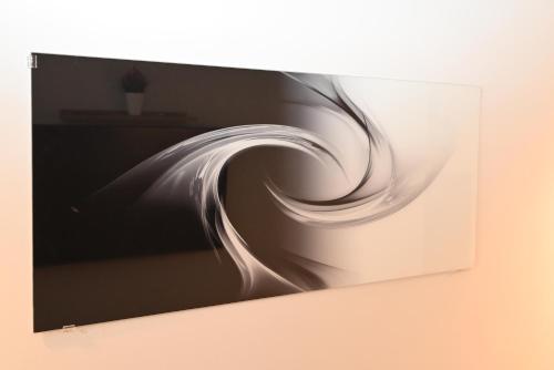 a painting of a white wave on a wall at Old Town Apartment in Omiš