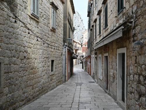 an alley in an old town with buildings at Old Town Apartment in Omiš