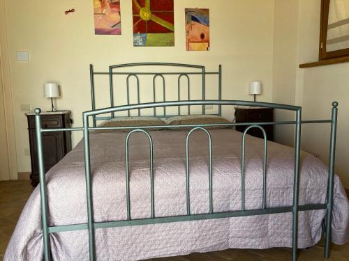 a bed in a bedroom with two night stands and two lamps at Casale Riorso in Orvieto
