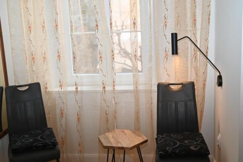 two chairs and a table in front of a window at Old Town Apartment in Omiš