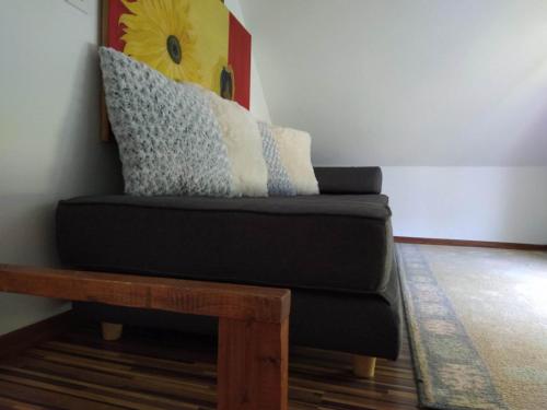 a black couch with pillows on top of a table at Guest House Bee in Visoko